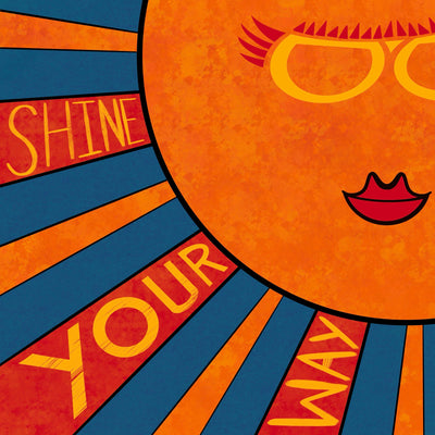 Orange and yellow illustrated sun with reddish accents and rays upon blue with words SHINE YOUR WAY